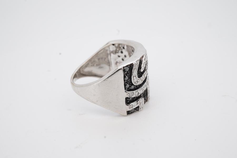 A recent 9ct white gold and two colour diamond cluster dress ring, of 'zebra' design, size N, gross weight 6.8 grams.